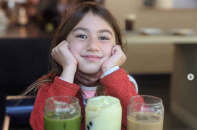 Girl posing with bubble tea in glass containers